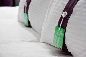 a green tag on a pillow with a price tag on it at Holiday Inn Bydgoszcz, an IHG Hotel in Bydgoszcz
