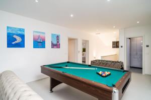 a room with a pool table and a couch at Suite Petmat in Dubrovnik