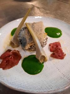 a white plate with food on a table at Jeux de Goûts in Hérissart