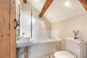 a bathroom with a toilet and a sink at The Hayloft in Notgrove