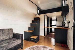 a living room with a couch and a counter at Olive Garden Tiny House in Kumluca