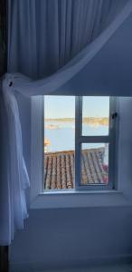 a window in a room with a view of the ocean at Portobello River and Sea View in Alvor