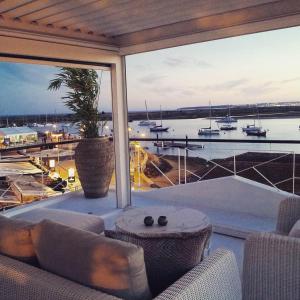 a living room with a large window with a view of a harbor at Portobello River and Sea View in Alvor