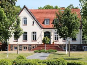 a large white house with a red roof at Gutshof Marienthal in Viereck