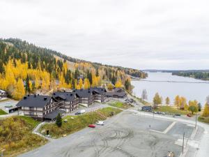 an aerial view of a resort with a parking lot and a lake at Hotel Tahko in Tahkovuori