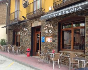 a group of tables and chairs outside of a restaurant at Hotel Casa Carmen in Benabarre