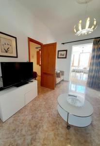 a living room with a tv and a coffee table at Casa El Rafal in Porreres