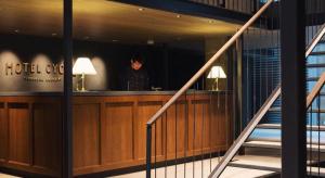 a woman standing at a bar in a building at Hotel Cycle in Onomichi +19 photos