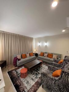 a living room with a couch and a zebra rug at فيلا ضاحية الرمال 2 in Riyadh