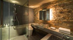 a bathroom with a sink and a glass shower at Hotel Cycle in Onomichi