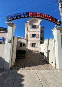 a building with a sign that reads hotel studios at Hotel Shkodra L in Shkodër
