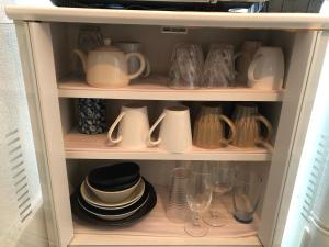 a cabinet filled with dishes and pitchers and glasses at KYOTO Guest House in Kyoto +14 photos
