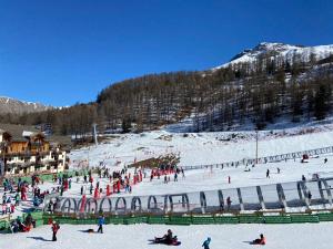 a group of people on a ski slope in the snow at Front neige 1800, cosy 4-6p, parking couvert in Les Orres