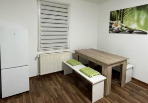 a small kitchen with a table and a table and a refrigerator at 4-Zimmer Wohnung in Wuppertal 6 Personen in Wuppertal