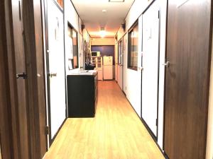 a hallway with a room with a kitchen and a hallway at KYOTO Guest House in Kyoto