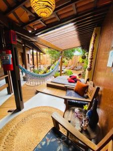 a patio with a hammock and a table and chairs at Beco Pousada Boutique in Fernando de Noronha