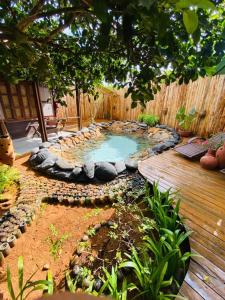 a small swimming pool in a backyard with a wooden deck at Beco Pousada Boutique in Fernando de Noronha