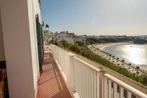 a balcony of a building with a view of the water at Manas Coliving in Sines