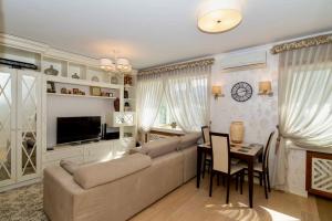 a living room with a couch and a table at Cozy studio apartment in the center of Riga in Riga
