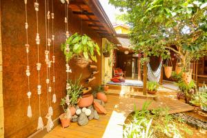 a patio with potted plants on the side of a house at Beco Pousada Boutique in Fernando de Noronha