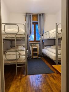 Zimmer mit 3 Etagenbetten und einem Fenster in der Unterkunft Appartamento Mont Fleury in Valtournenche