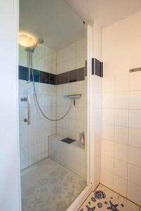 a bathroom with a shower with a glass door at Mein Haus in Pellworm