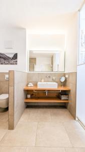 a bathroom with a sink and a mirror at Chalet am Breitenberg Appartement CB 11 in Pfronten