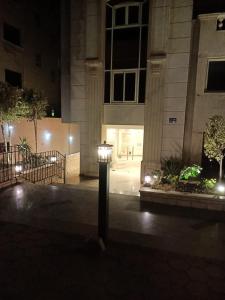 a street light in front of a building at night at Luxury Apartment In Massaken Sheraton near Cairo Int'l Airport in Cairo