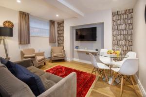 a living room with a couch and a table and chairs at The Wesley in York