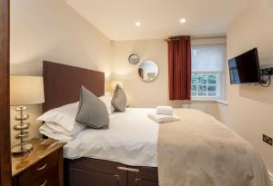 a bedroom with a large white bed and a window at The Wesley in York