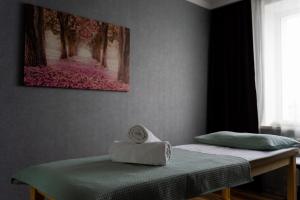 two beds in a room with a towel on a table at Premier Inn Astana in Astana