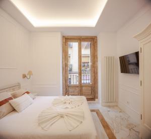Łóżko lub łóżka w pokoju w obiekcie Plaza España V calle San Bernardino 6BR 6BH
