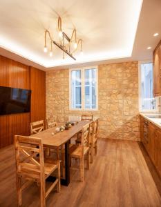 a dining room with a wooden table and a stone wall at San Bernardino 15 in Madrid