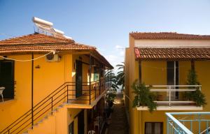 an alley between two buildings with yellow at Evgenios Studios in Kavos