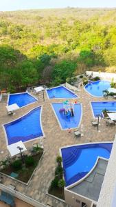 an overhead view of three pools in a resort at Park Veredas Flat Service in Rio Quente