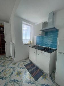 a kitchen with a sink and a stove at Villa sul mare in Massa Lubrense