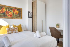 a bedroom with a white bed and a chair at ALTIDO Comfy flat with balcony in Milan
