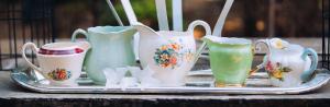 a tray of vases and cups on a table at Blue Bell Guesthouse in Tzaneen +24 photos
