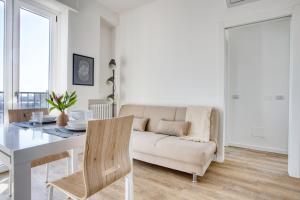 a living room with a table and a couch at ALTIDO Comfy flat with balcony in Milan