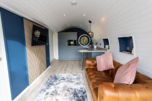 a living room with a couch and a table at The Lodge @Quarrywood in Tenby