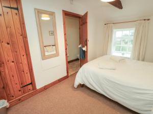 a bedroom with a bed and a window at The Cottage in Pickering