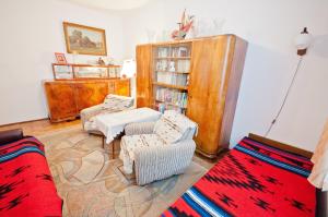 a living room with two chairs and a book shelf at Willa Wanda in Zakopane