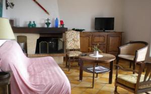 a living room with a tv and a table and chairs at "villa mona" a 700 m de la mer in Grimaud