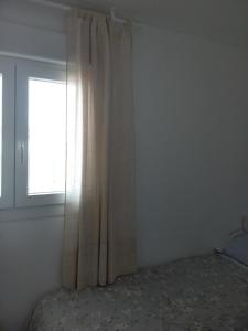 A bed or beds in a room at Verdemar Apartamento l