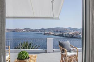 a balcony with a view of the water at Pafsilipon Suites in Ermoupoli