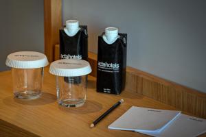 a wooden table with two glasses and a bottle on it at Acta The Clover in Porto