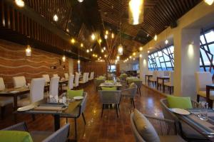 a dining room with tables and chairs in a restaurant at Empyrean Dhaka City Centre in Dhaka