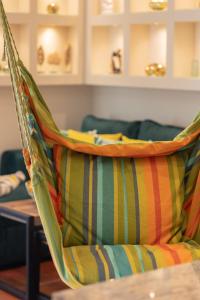 a hammock with a colorful pillow on a table at Mokotów Unique & Pet-Friendly Apartment by Renters in Warsaw