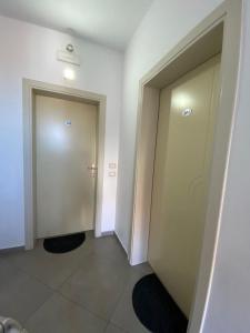a hallway with two elevators and two doors at Hotel Shkodra L in Shkodër