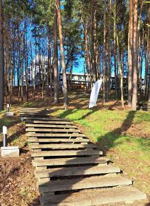 a stone pathway with an umbrella on the grass at Apartament Nad Zalewem Zegrzyńskim in Serock